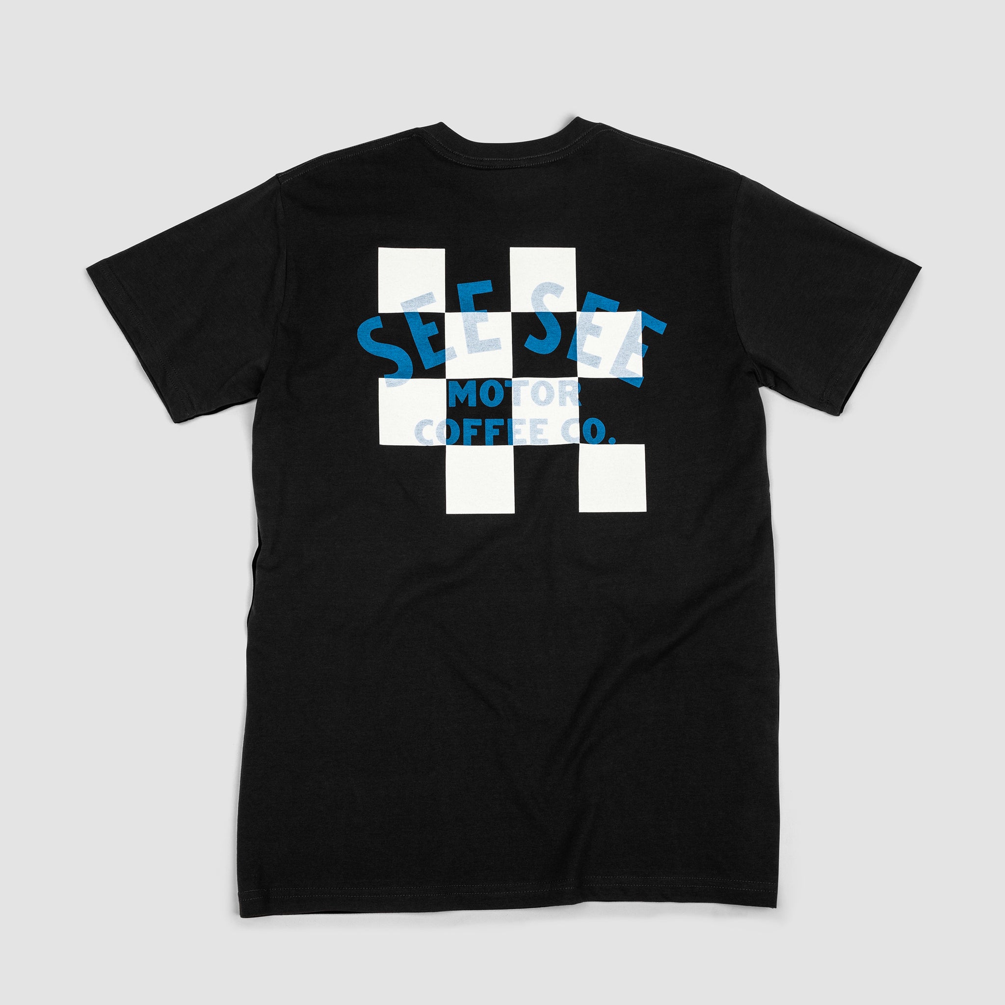 Back of black unisex t-shirt with white and black checkered center on the back. Blue See See Motor Coffee Co. text overlay.