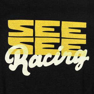 Front detailed shot of boxy yellow See See logo design with the word racing in a white cursive overlay.