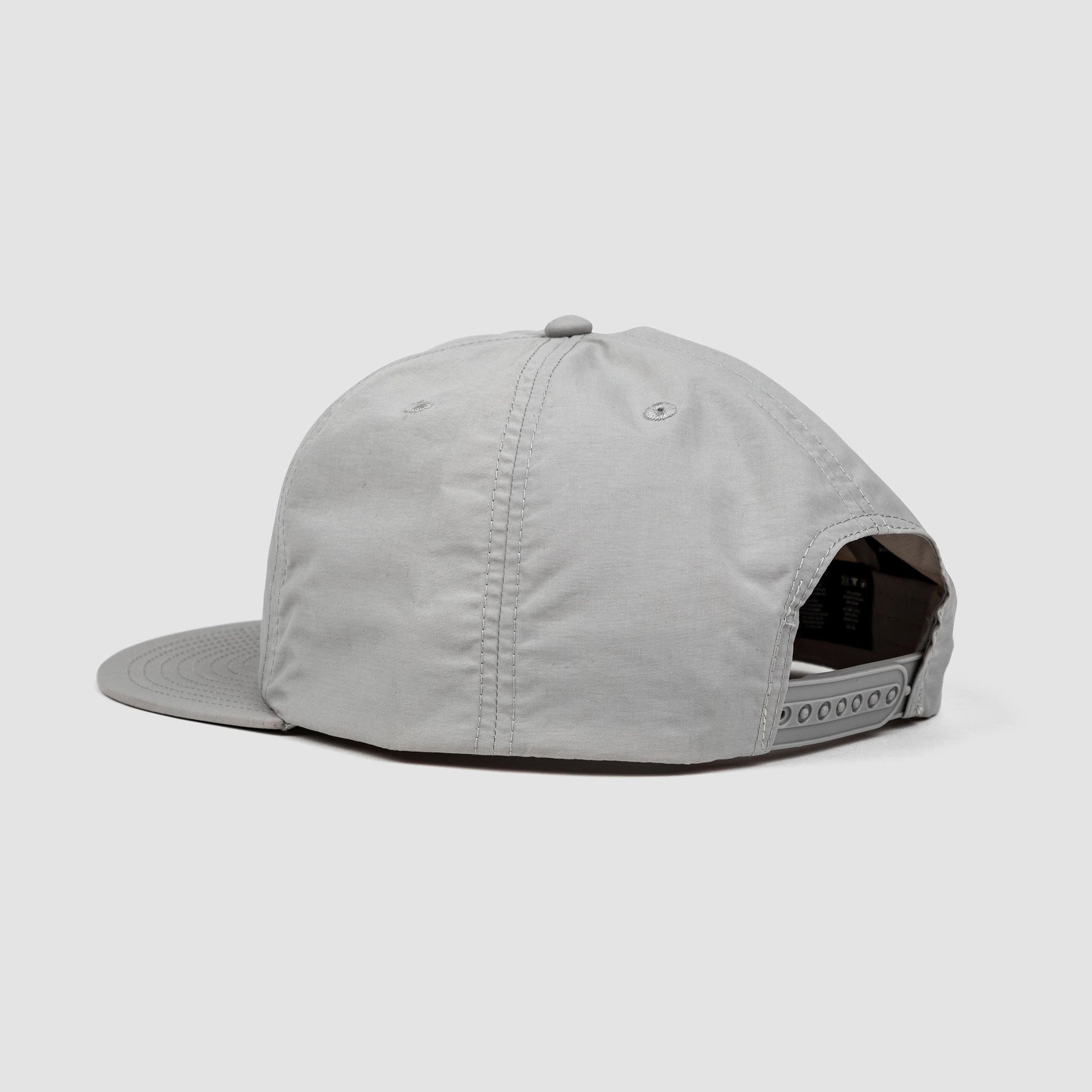 Back shot of gray unisex adult surf-style 5-panel hat with adjustable snap closure.