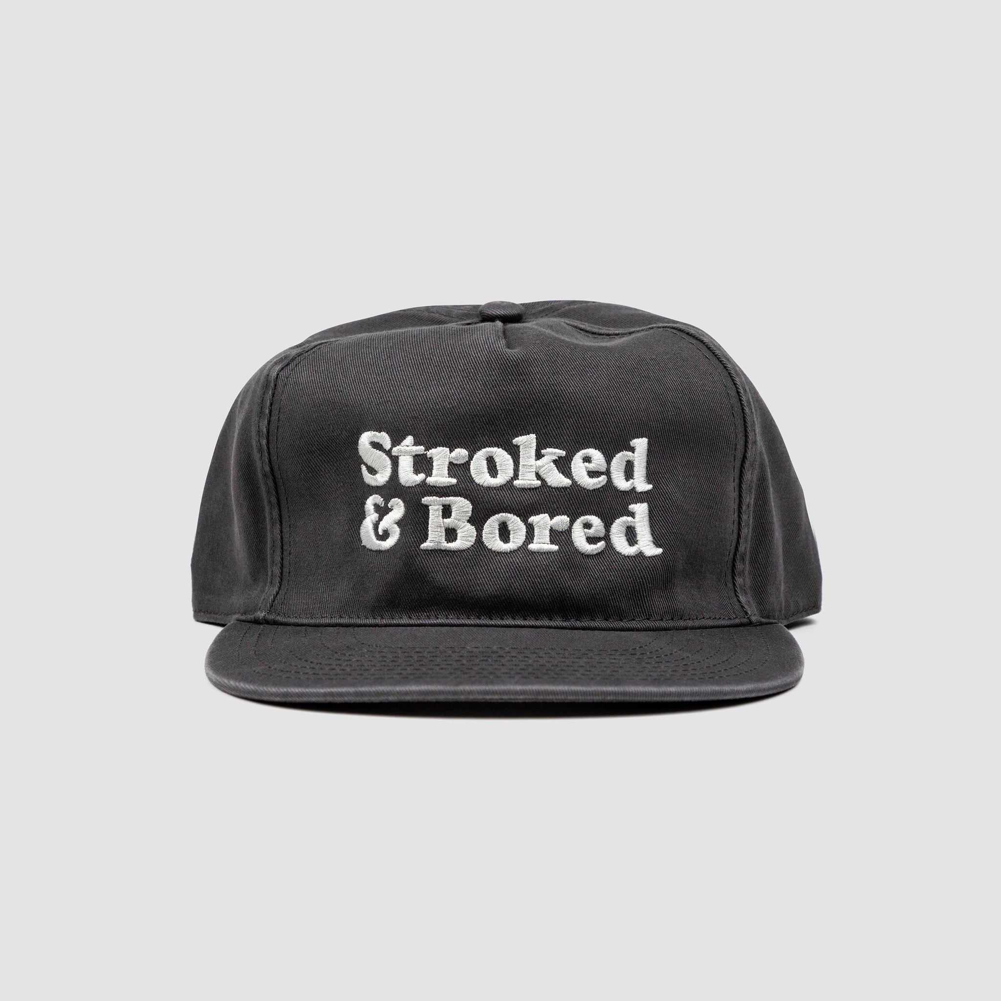 Front shot of dark gray cotton unisex 5-panel hat. Centered text in white embroidery reads Stroked & Bored. 