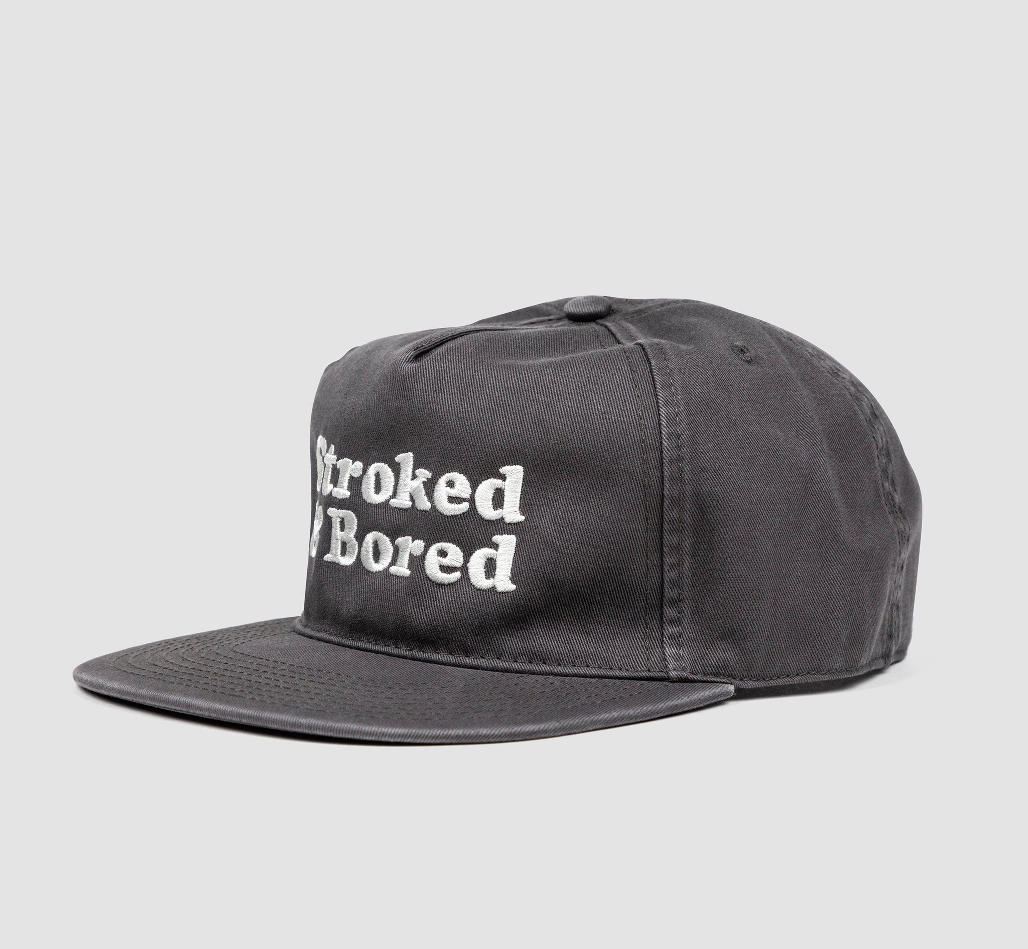Side angle shot of dark gray cotton unisex 5-panel hat. Centered text in white embroidery reads Stroked & Bored. 